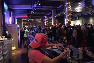 Interior crowd under string lights.