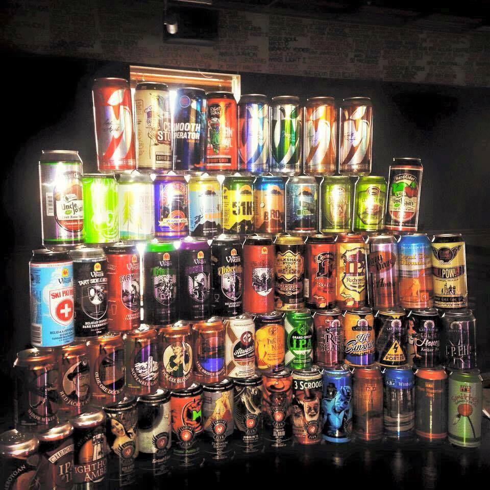 The can wall — a pyramid of craft cans behind the bar.