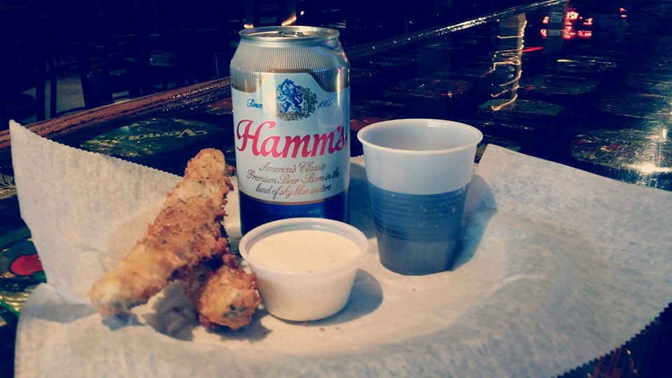 Fried pickles and wings with a cold can of beer.